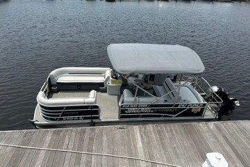 a boat that is sitting on a dock next to a body of water