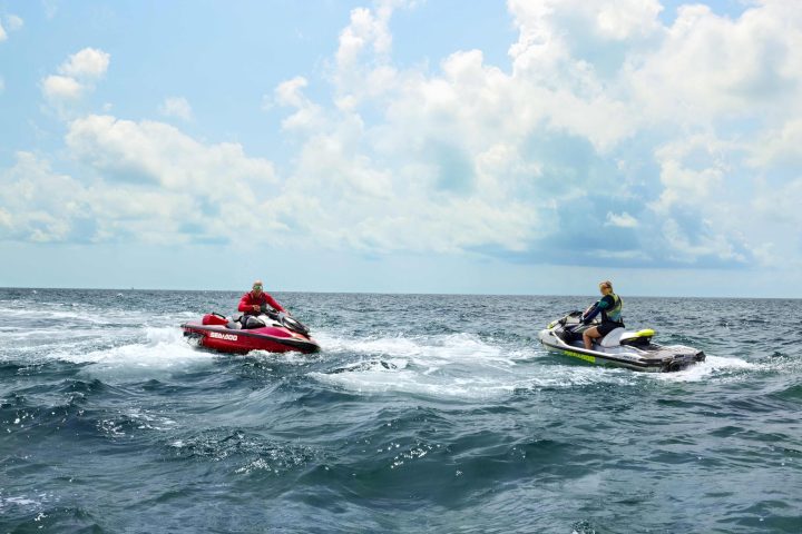 a man riding on the back of a boat in a body of water