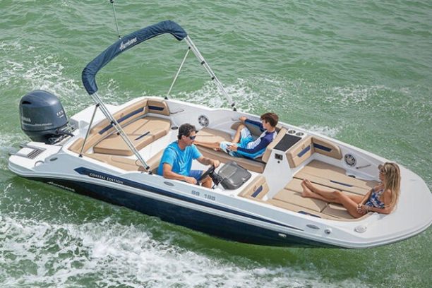 a person riding on the back of a boat in the water