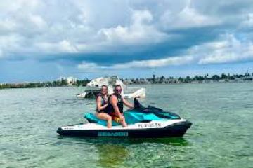 a person riding on the back of a boat in the water