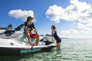 a man standing next to a body of water