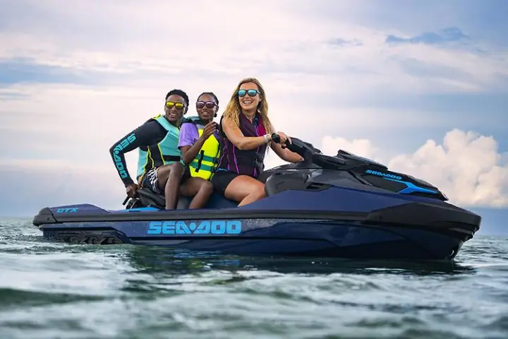 a person riding on the back of a boat in the water