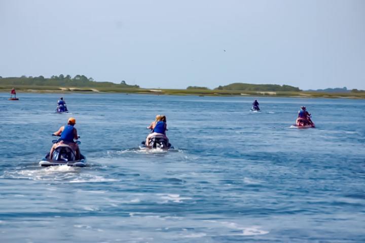 a group of people riding skis on a body of water