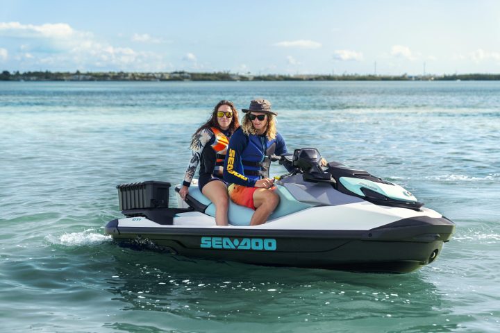 a person riding on the back of a boat in a body of water
